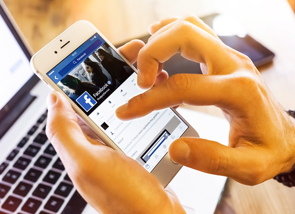 Closeup of hands holding a mobile phone and scrolling