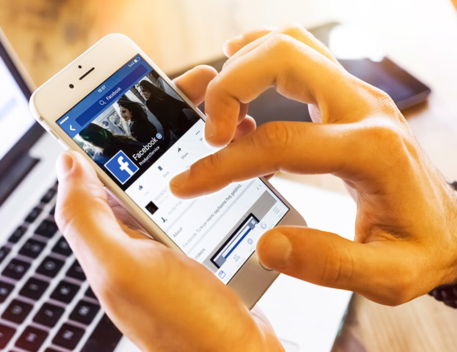 Closeup of hands holding a mobile phone and scrolling