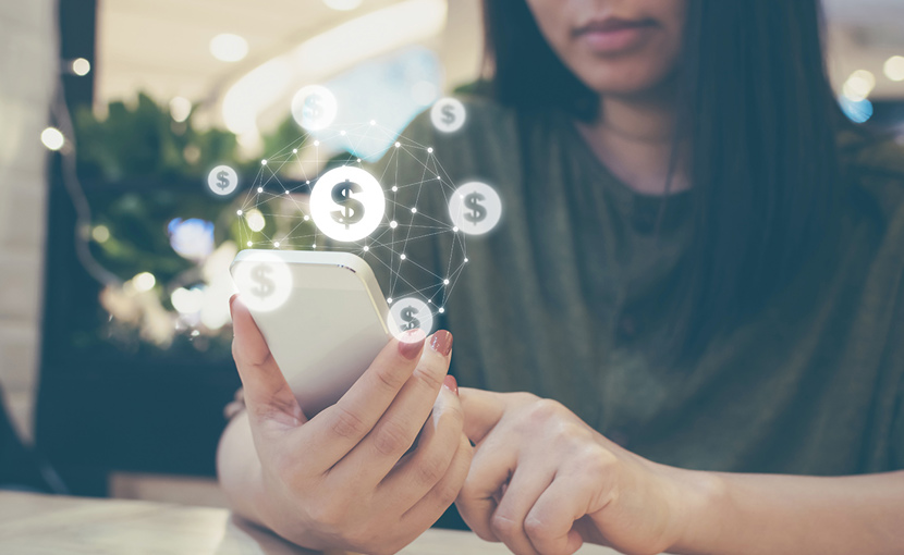 Person holding a smartphone with dollar sign graphics overlaid