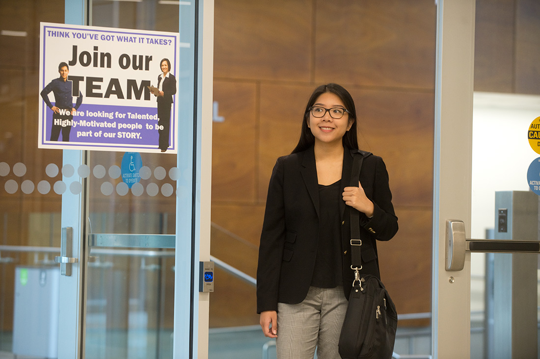 Job seeker walking through a doorway with a "Join our team" sign posted