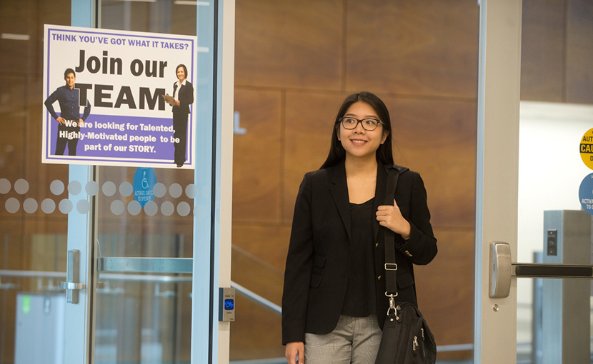 Job seeker walking through a doorway with a "Join our team" sign posted