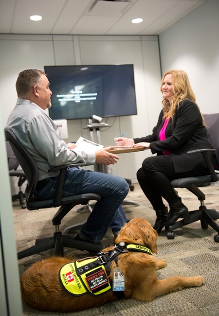 Person with a service dog in an interview