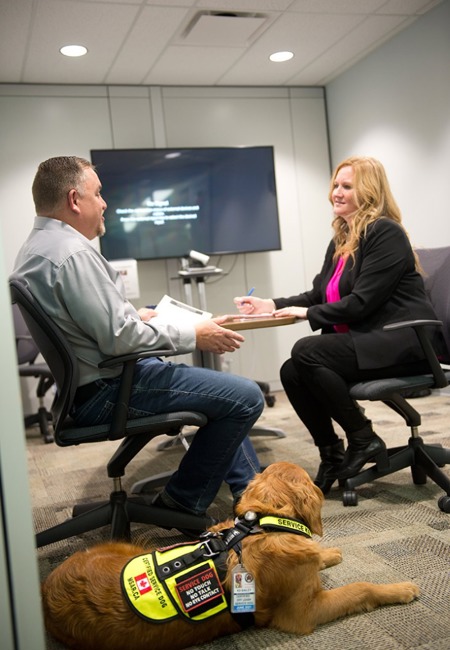 Person with a service dog in an interview