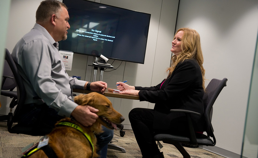 Person with service dog meeting in a board room