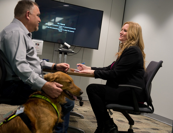 Person with service dog meeting in a board room