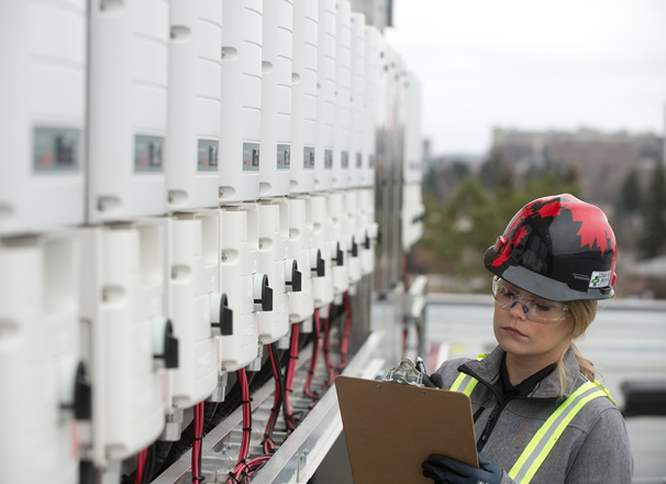 Solar technician wearing a hard hat at a jobsite