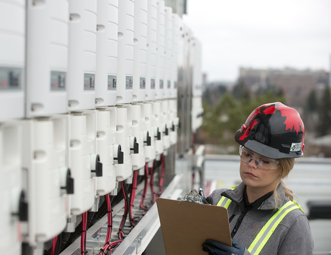 Solar technician wearing a hard hat at a jobsite