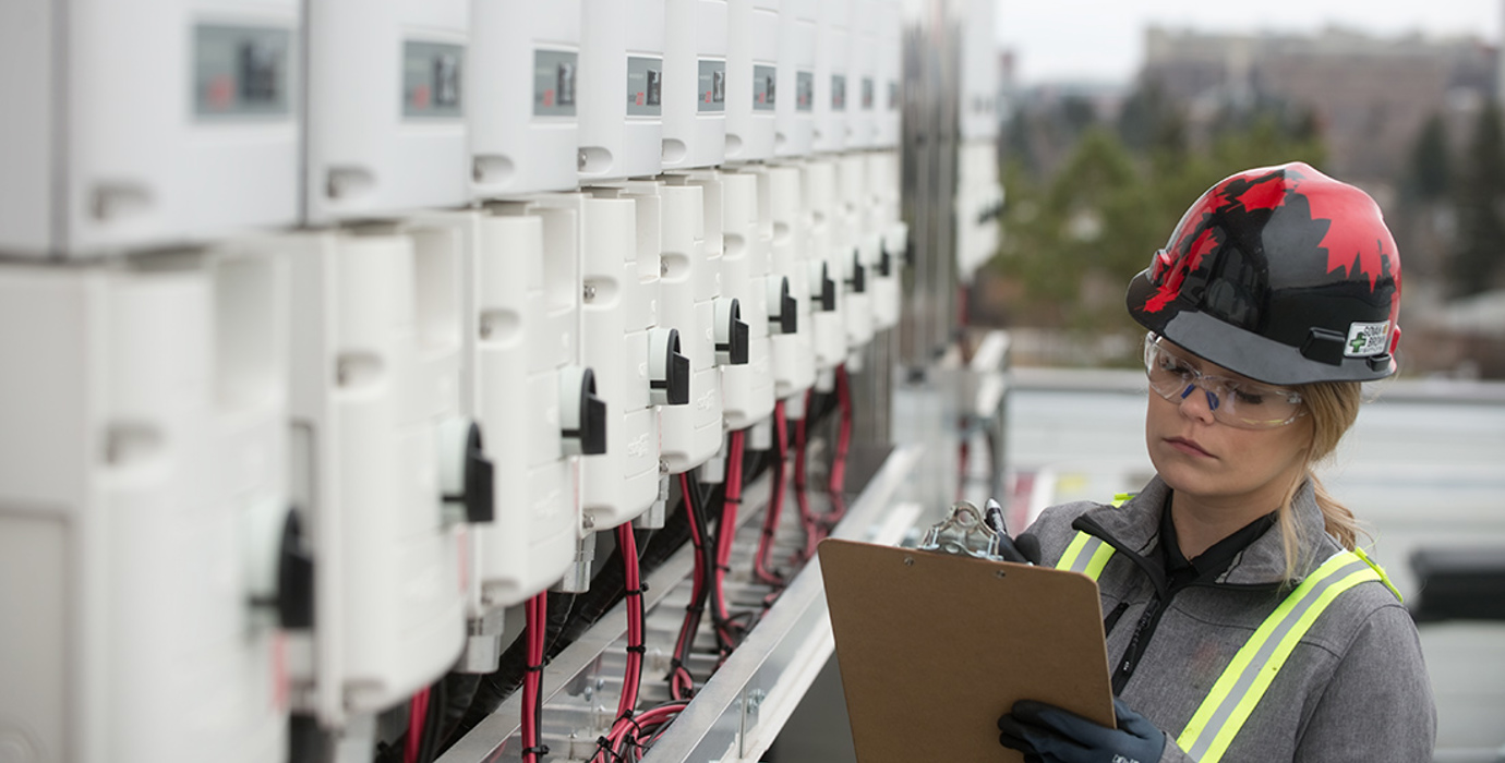 Solar technician wearing a hard hat at a jobsite