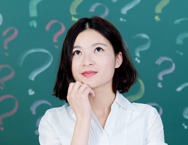 Person looking up with chin in hand in front of a background of question marks