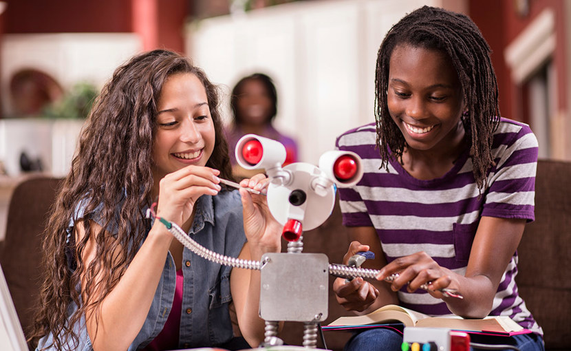 High school students building a robot in a classroom
