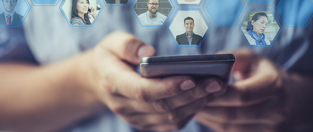 Hands holding a smartphone with profile photos of their network coming out of the phone