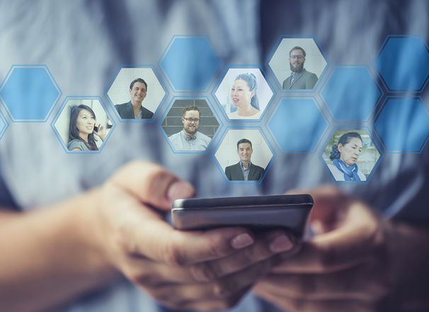 Hands holding a smartphone with profile photos of their network coming out of the phone
