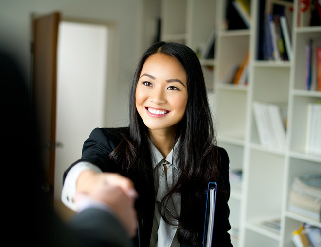 Person in business attire shaking hands