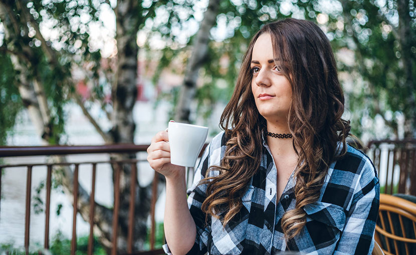 Person drinking coffee outside