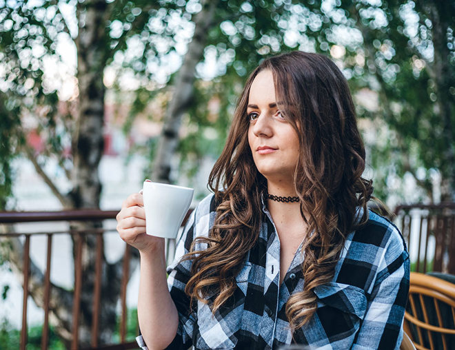 Person drinking coffee outside