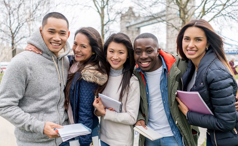 Post-secondary students standing in London with Tower Bridge in the background