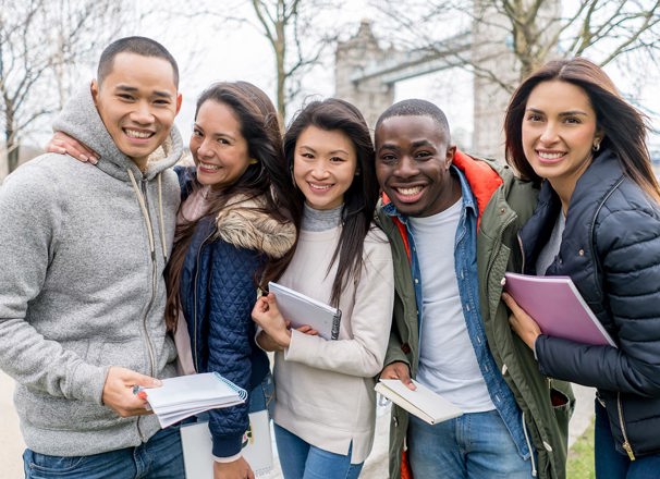 Post-secondary students standing in London with Tower Bridge in the background