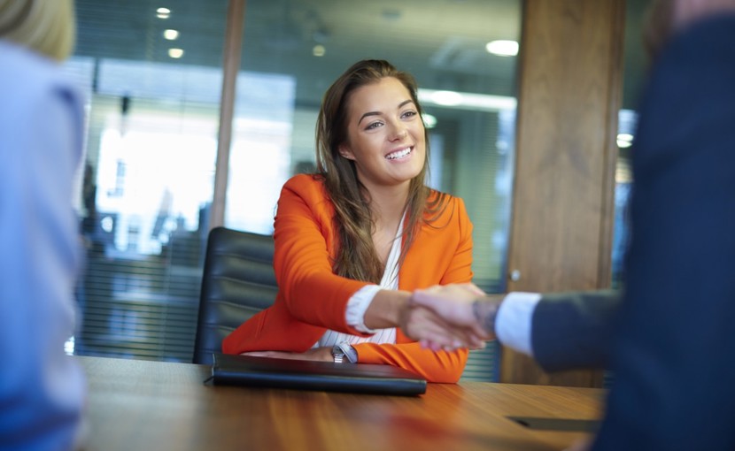 Interviewee shaking hands with job interviewer