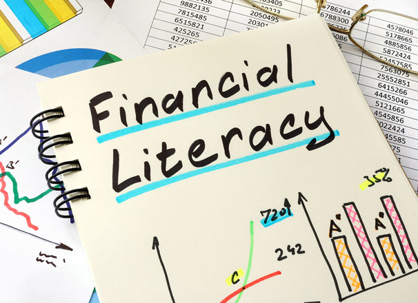 Notebook with colourful graphs with handwritten title "Financial Literacy"