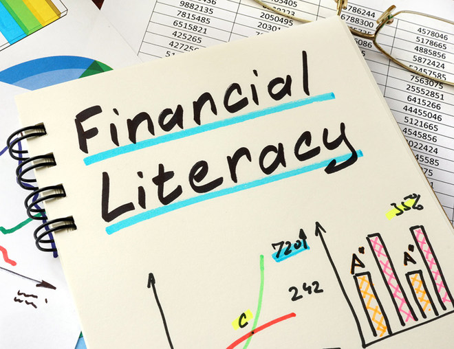 Notebook with colourful graphs with handwritten title "Financial Literacy"