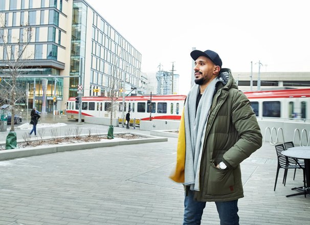 Person walking downtown wearing a winter coat and scarf