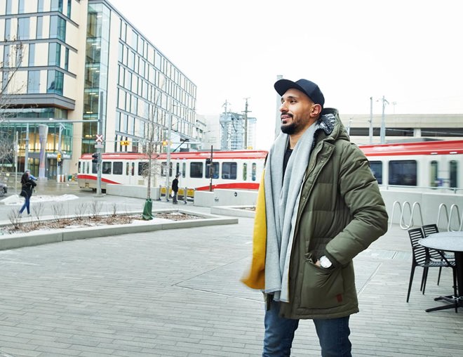 Person walking downtown wearing a winter coat and scarf