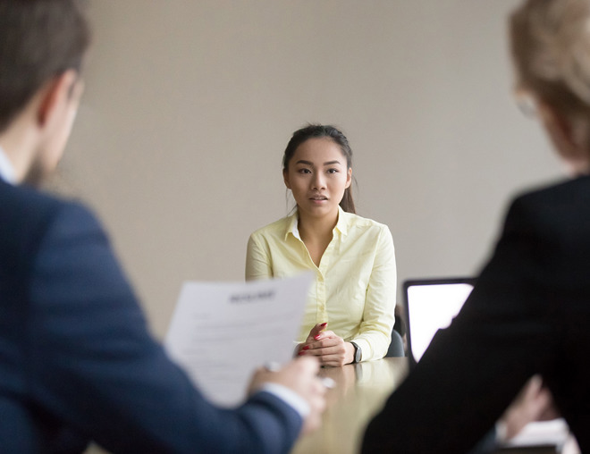 Job seeker facing 2 interviewers in a meeting room