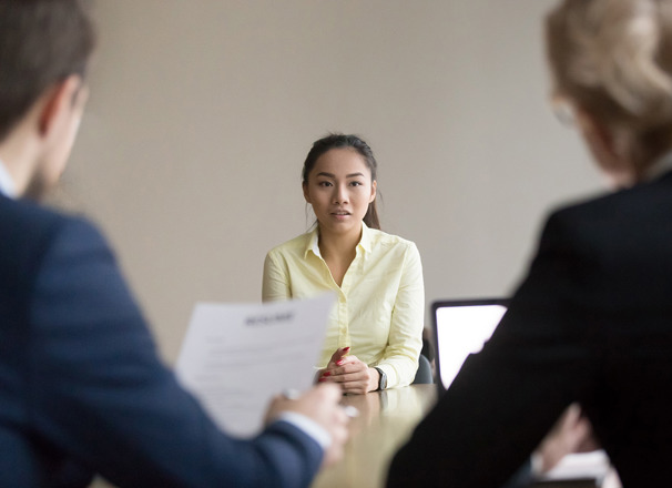 Job seeker facing 2 interviewers in a meeting room