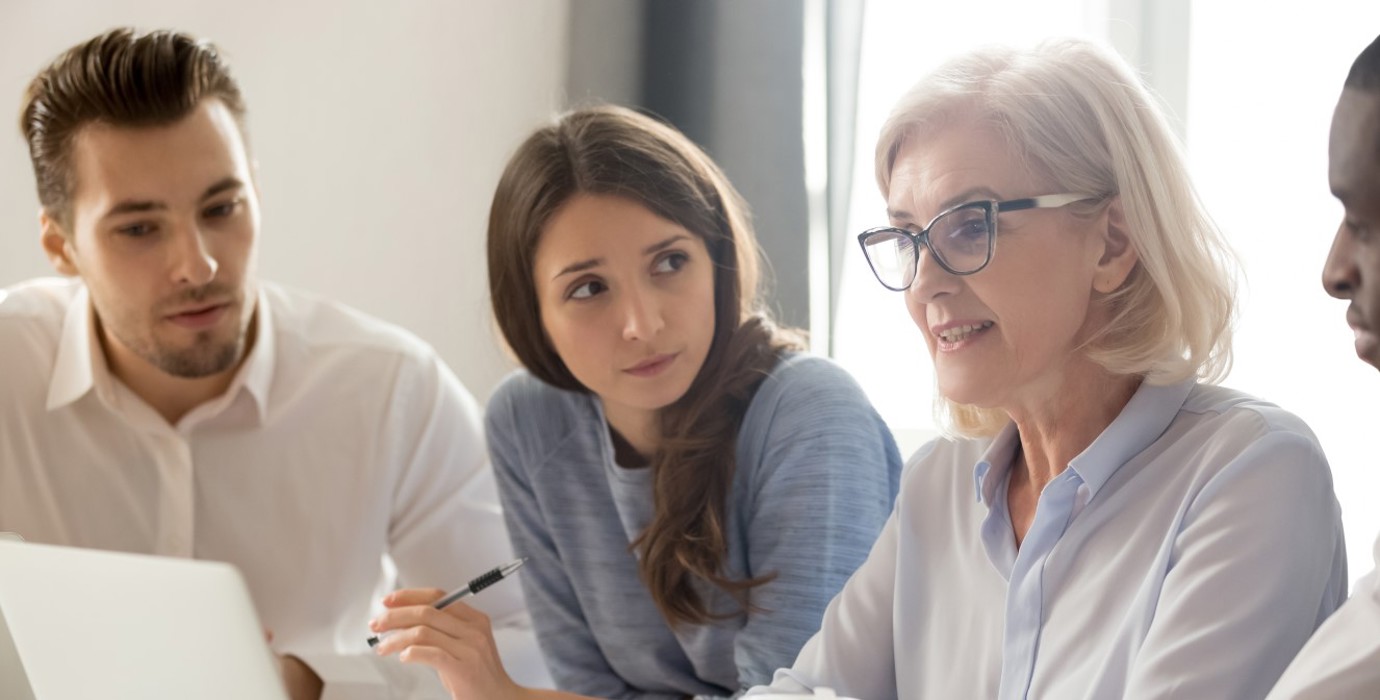 Mature worker in a meeting with coworkers