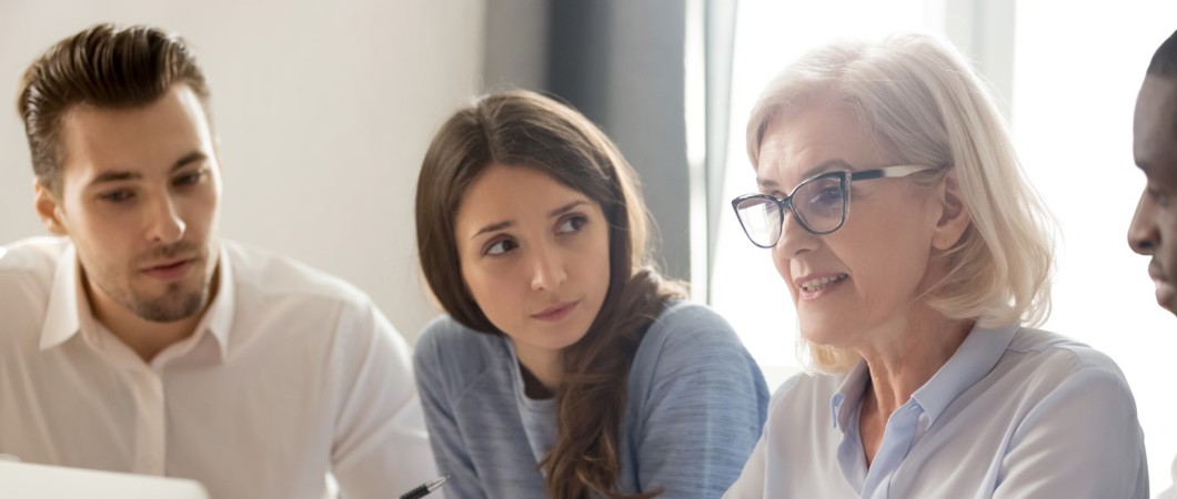 Mature worker in a meeting with coworkers
