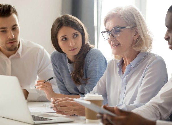 Mature worker in a meeting with coworkers