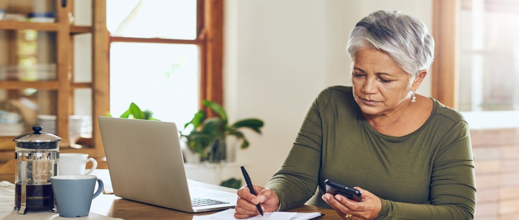 Person taking notes at a kitchen counter