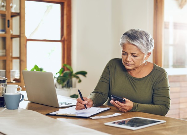 Person taking notes at a kitchen counter