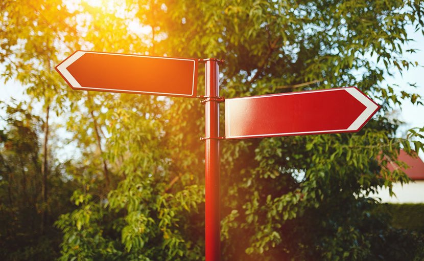 Red signpost with 2 arrows pointing left and right