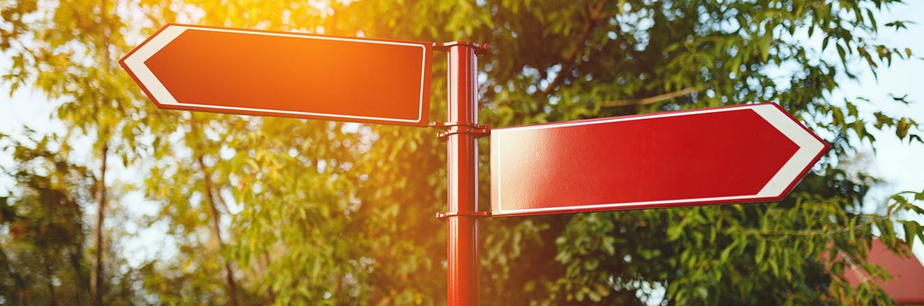 Red signpost with 2 arrows pointing left and right