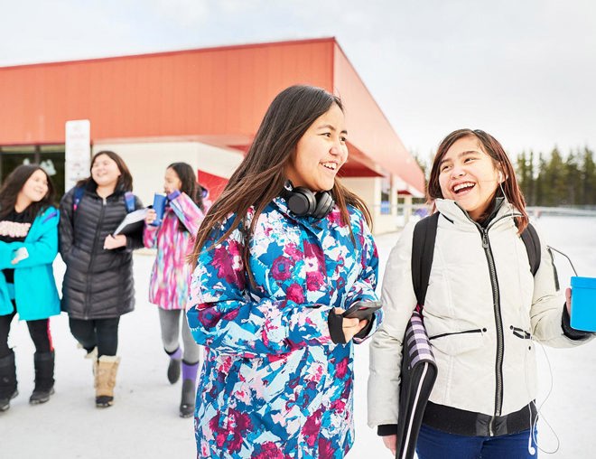 Young students leaving school during the winter.
