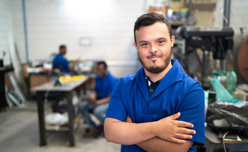 A worker standing in a repair shop.
