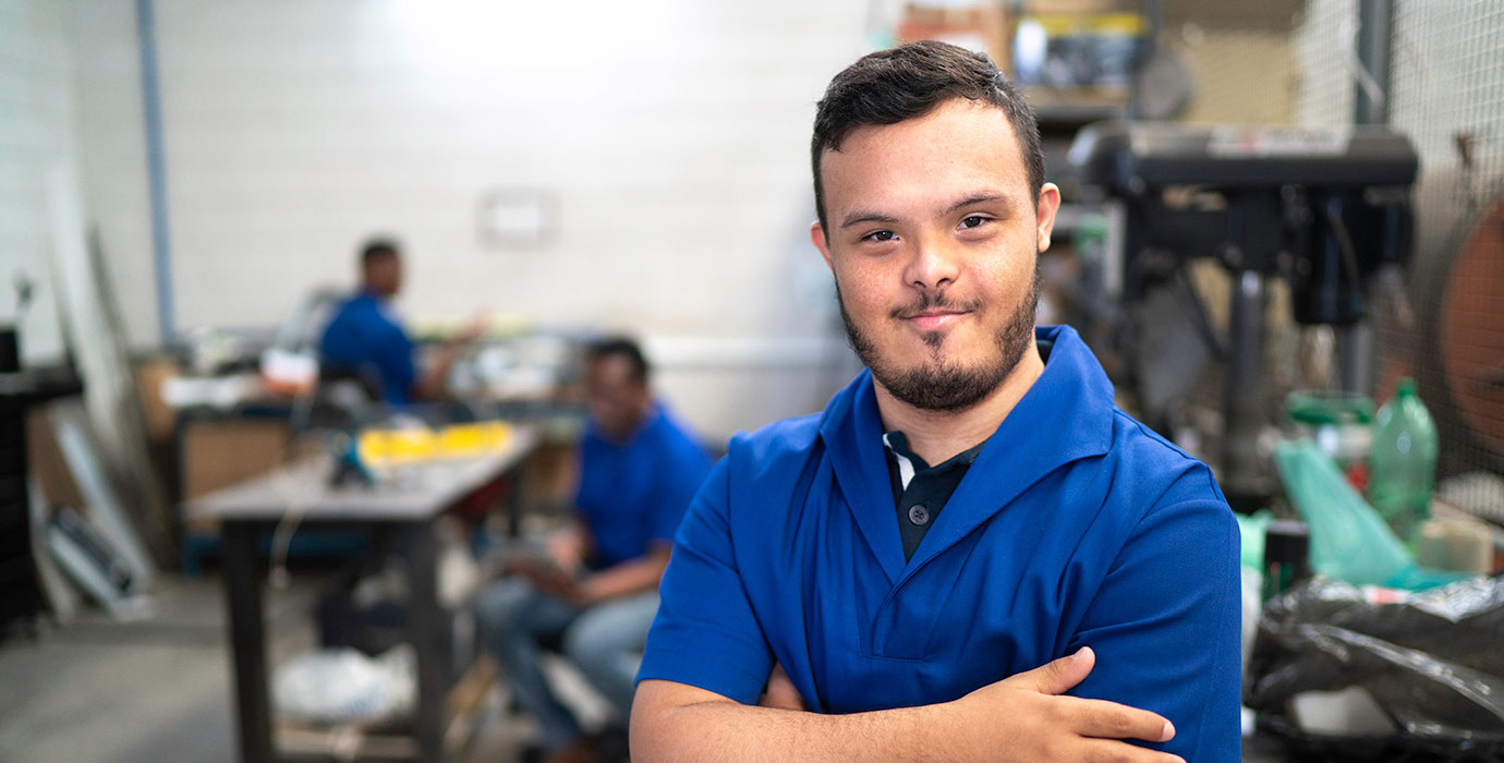 A worker standing in a repair shop.