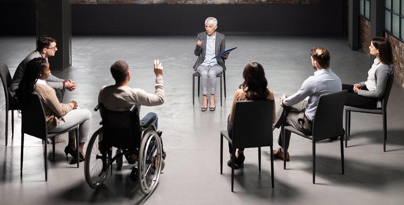 6 people and a moderator in a group therapy session.