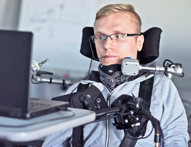 A student with a disability using assistive technology in a classroom.