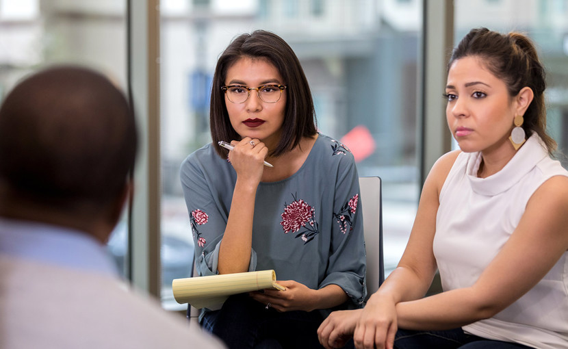 3 people have a serious discussion in the workplace.