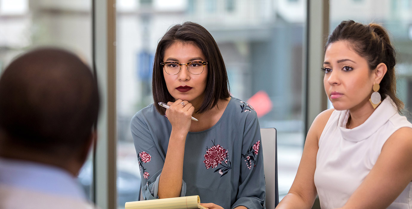 3 people have a serious discussion in the workplace.