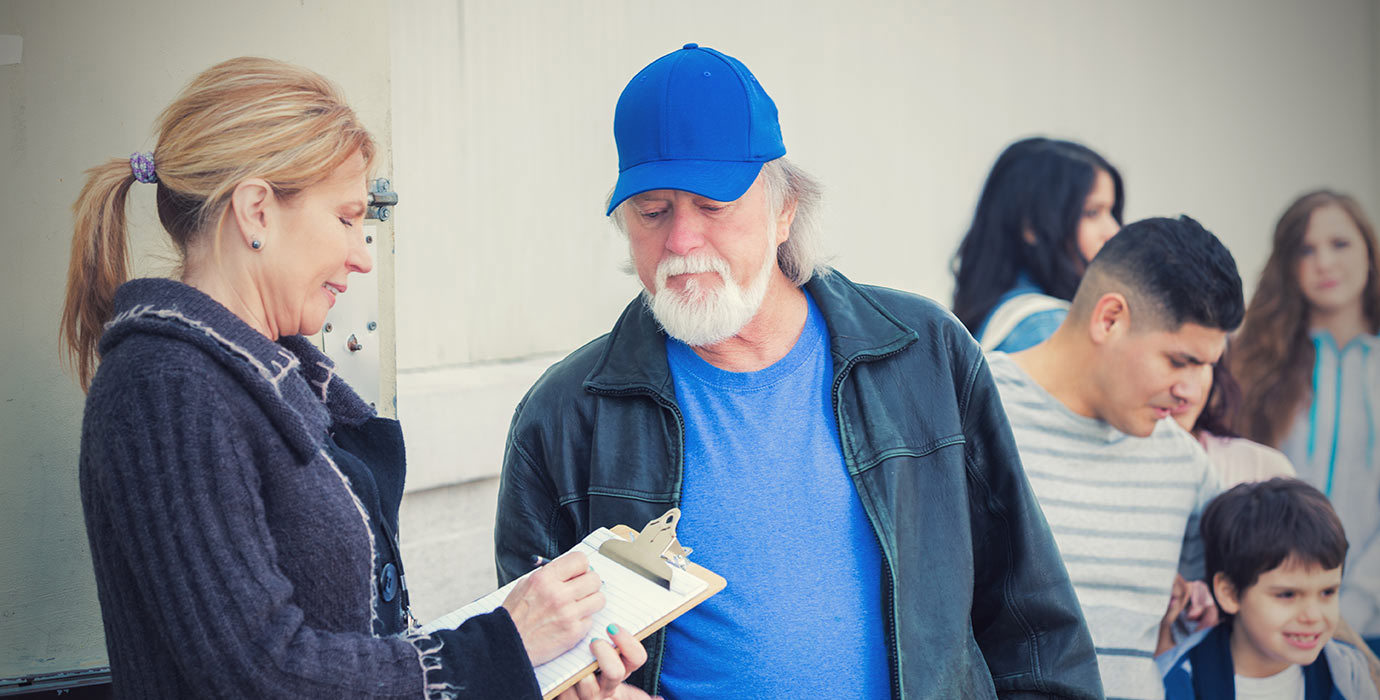 People line up for assistance at a shelter.