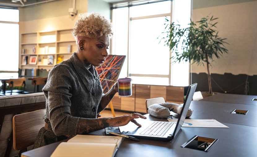 A businessperson works with a laptop in a coworking space.