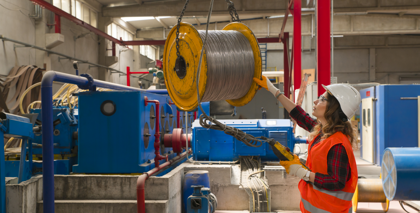Crane operator moving spool.