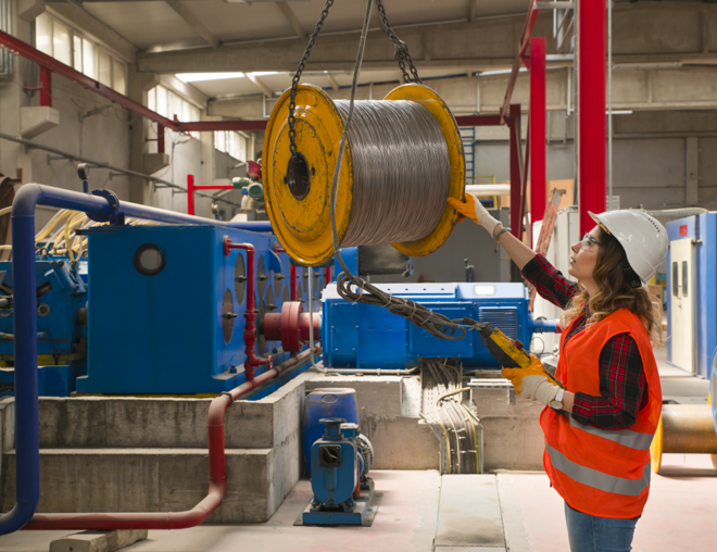 Crane operator moving spool.