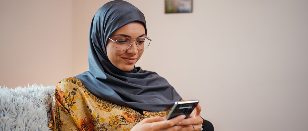 Person using smartphone while sitting on couch.