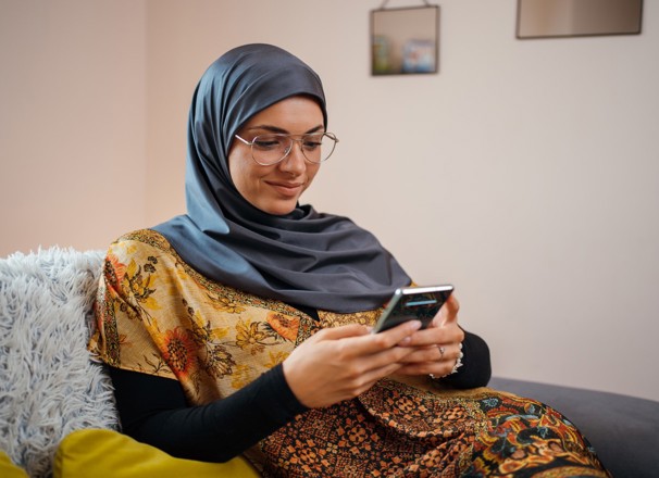 Person using smartphone while sitting on couch.