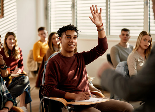 Student raising hand in classroom