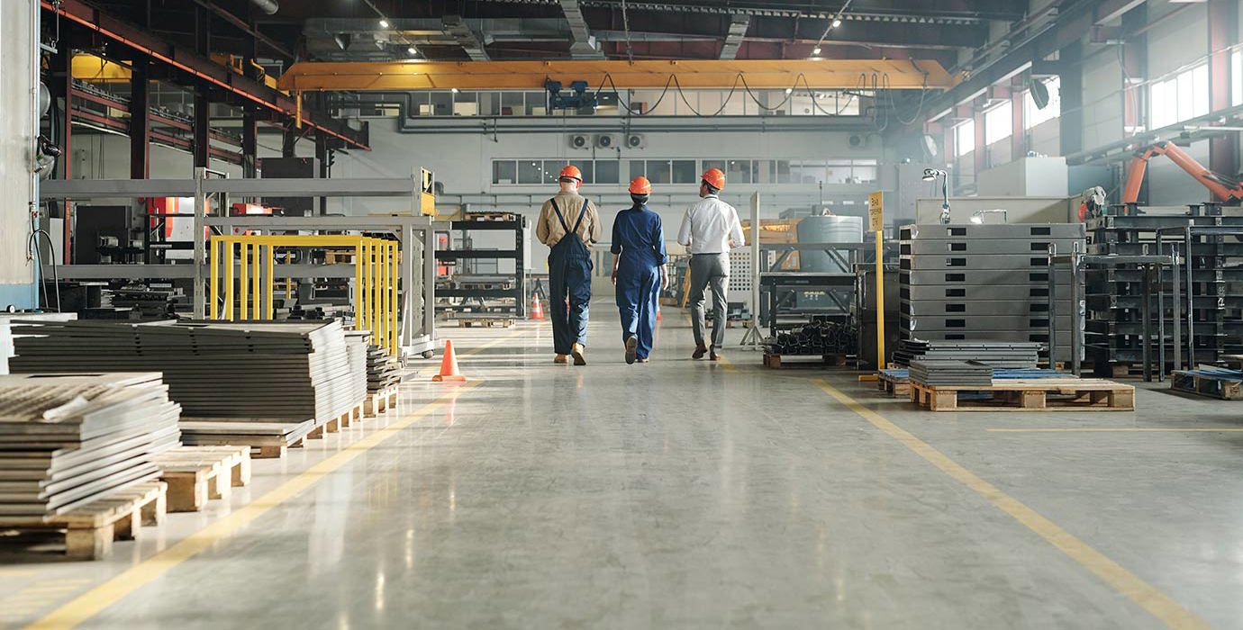 3 workers walking through an industrial building
